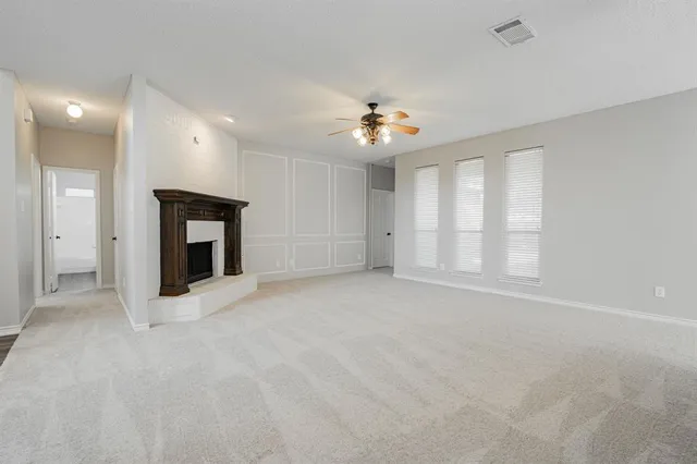 a view of an empty room with a fireplace