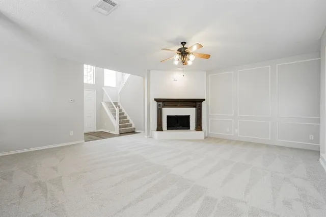 a view of an empty room with a fireplace