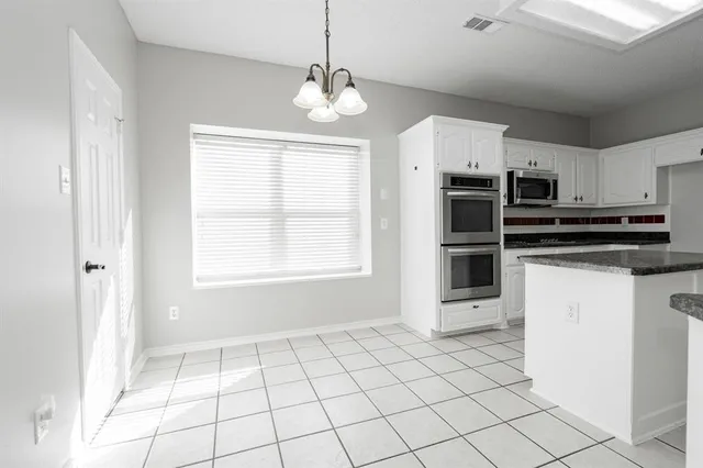 a kitchen with stainless steel appliances a stove a sink and a refrigerator