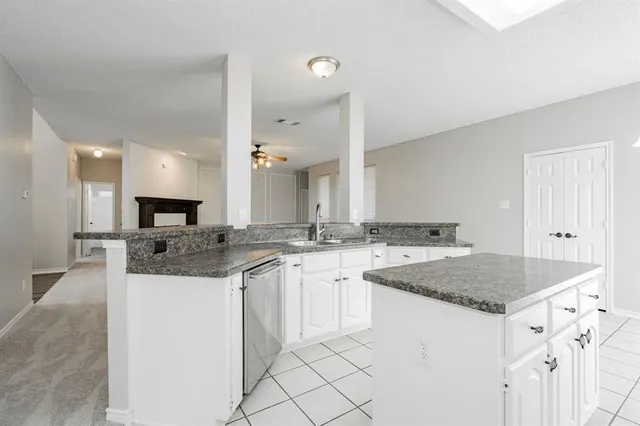 a kitchen with a sink and cabinets