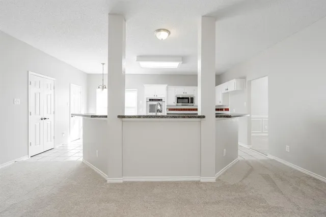 a view of kitchen with white cabinets