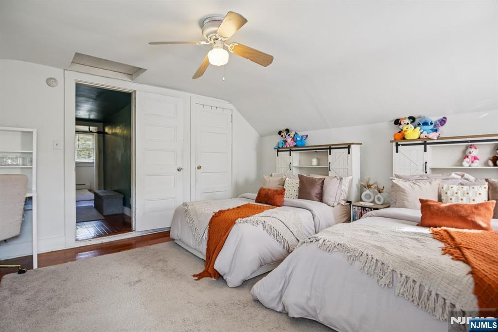 369 Queens Court Ridgewood, NJ 07450 - Photo 11 of 40 a bedroom with two beds and a chandelier