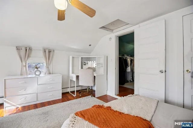 a living room with baby crib and couch