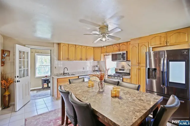 a kitchen with granite countertop a sink a center island and cabinets