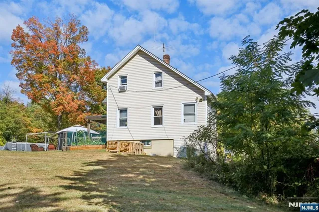 a view of house with yard and green space