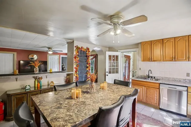 a large kitchen with a table and chairs