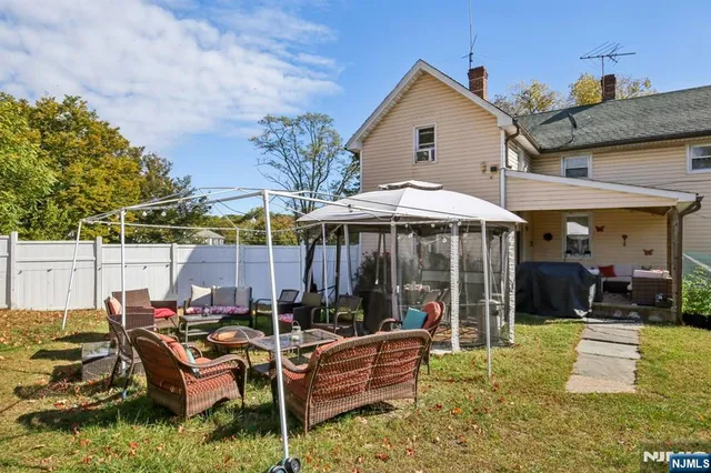 a view of a house with a yard and garage