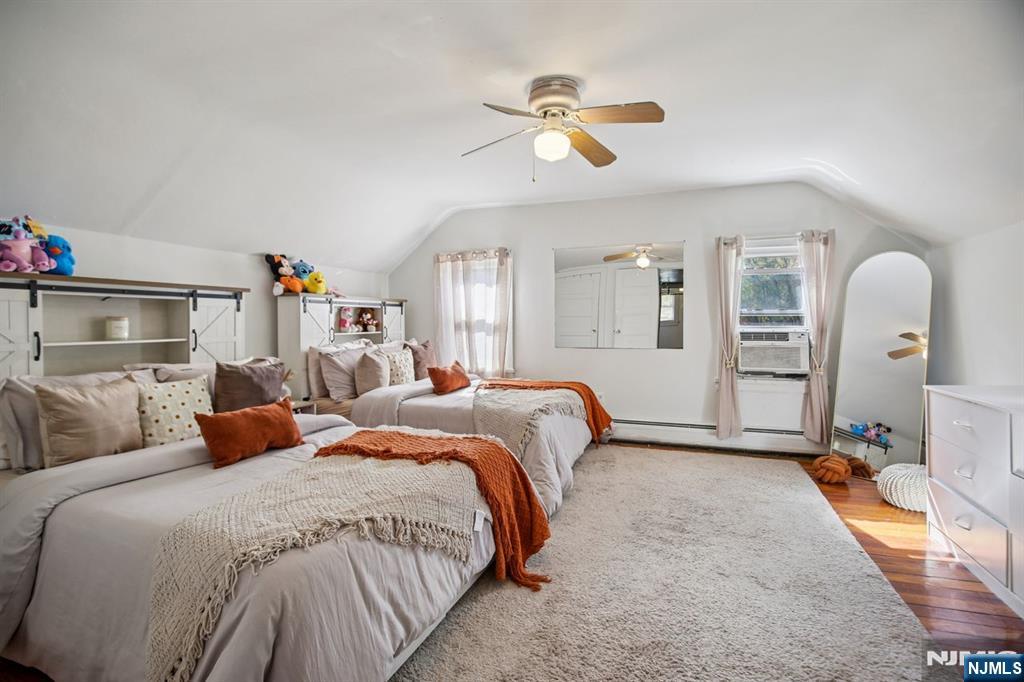 369 Queens Court Ridgewood, NJ 07450 - Photo 10 of 40 a bedroom with bed and a chandelier