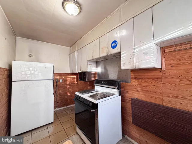 a kitchen with a refrigerator and a sink