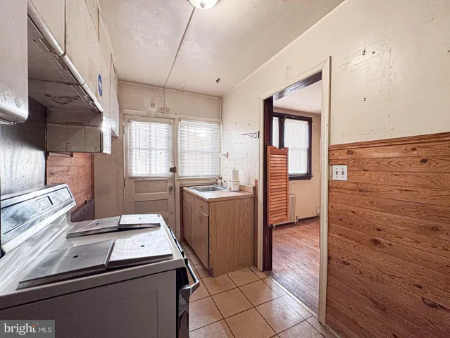 a kitchen that has a sink and a stove in it