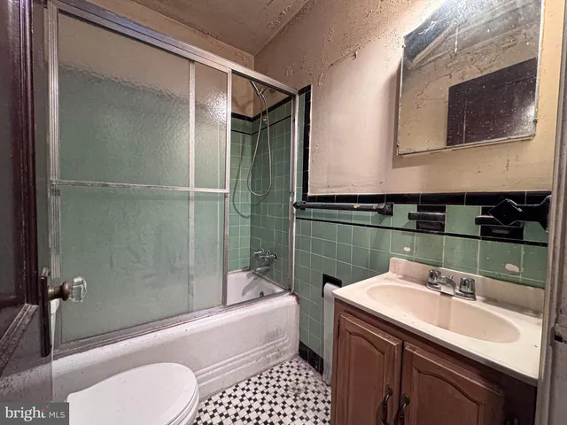 a bathroom with a sink a toilet and bathtub