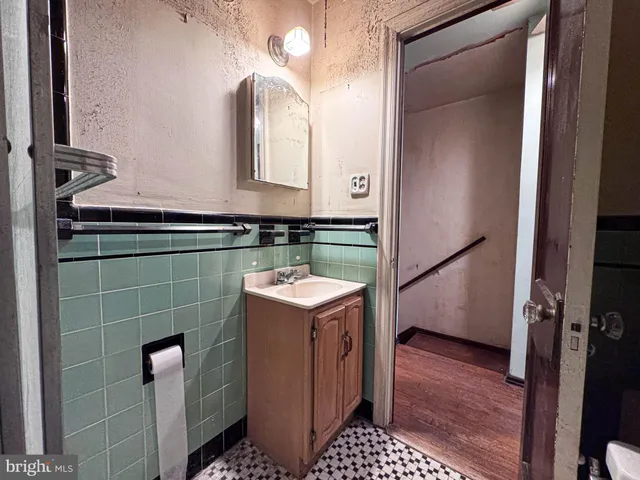 a bathroom with a sink a toilet and mirror