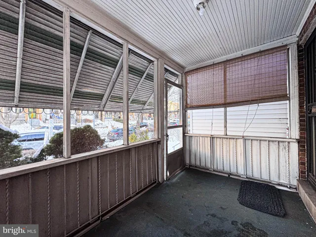a view of a porch with wooden floor