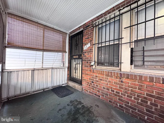 a view of a brick house with an outdoor space