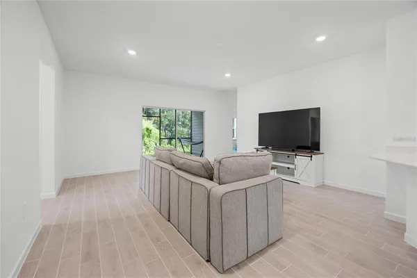 a kitchen with a white cabinets and wooden floor