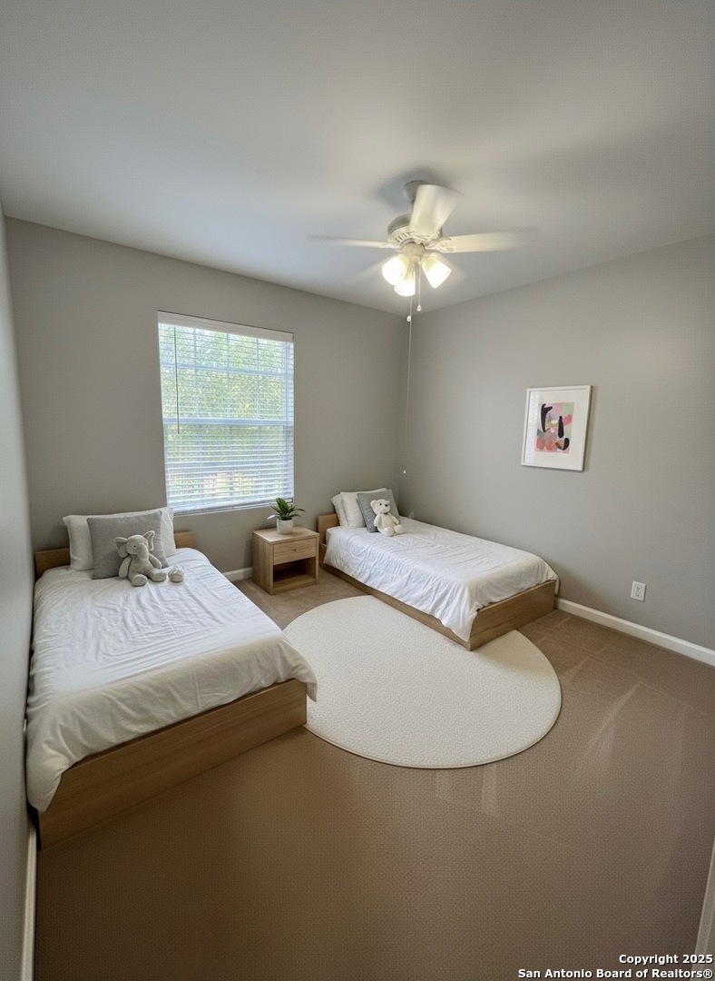 9135 Rue De Lis San Antonio, TX 78250 - Photo 17 of 23 a bedroom with double bed and a chandelier