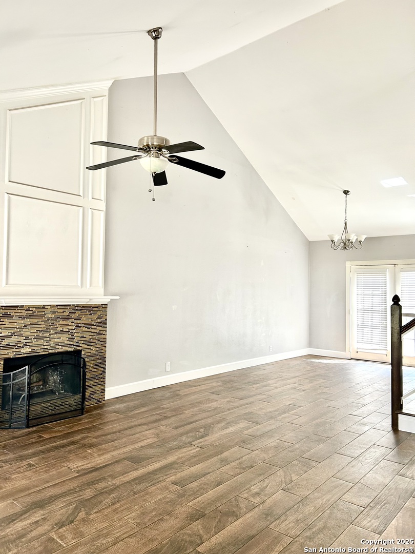 9135 Rue De Lis San Antonio, TX 78250 - Photo 2 of 23 an empty room with wooden floor a fireplace