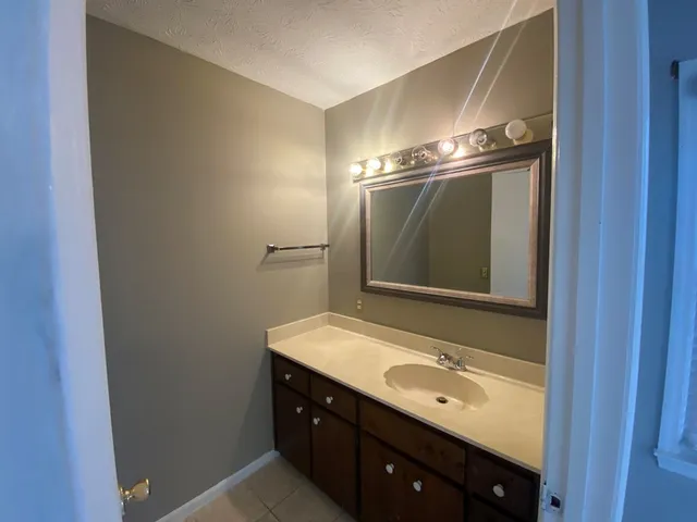 a bathroom with a double vanity sink and mirror