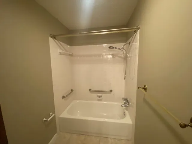 a bathroom with a shower and a bath tub