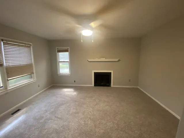 a view of empty room with a fireplace