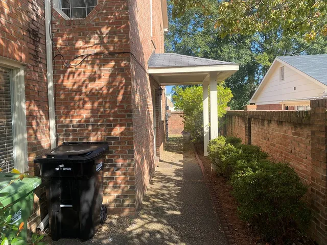 a backyard of a house with lake view and a potted plant