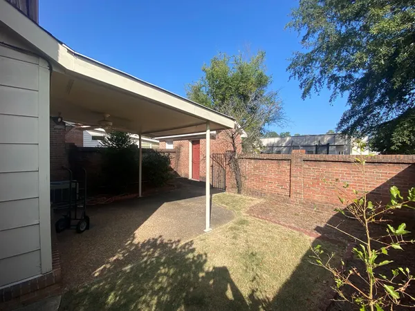 a backyard of a house with table and chairs
