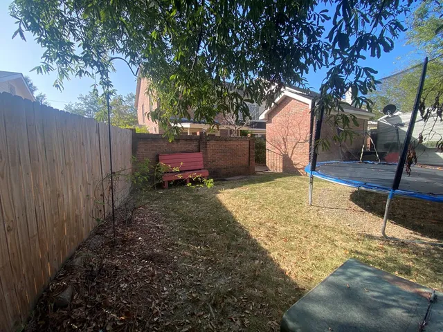a backyard of a house with table and chairs