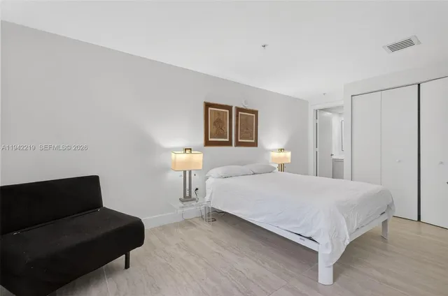 a bedroom with a bed and a lamp