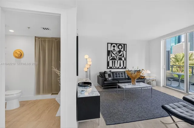 a bathroom with a toilet sink vanity and mirror