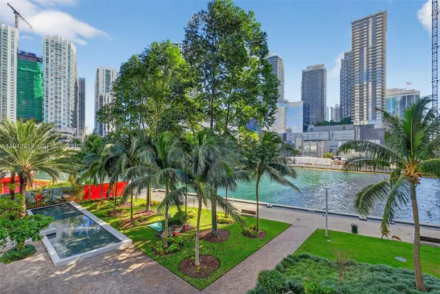 a swimming pool with outdoor seating and plants
