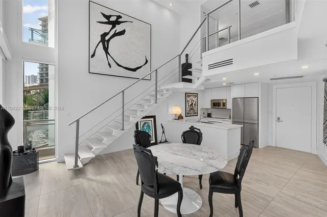 a dining room with furniture and a chandelier