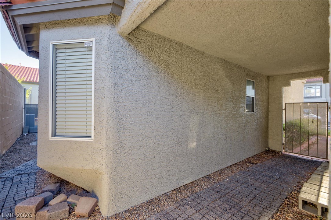 2246 Ramsgate Drive Henderson, NV 89074 - Photo 27 of 36 A private, covered entryway offers a shaded pathway to the home's entrance.