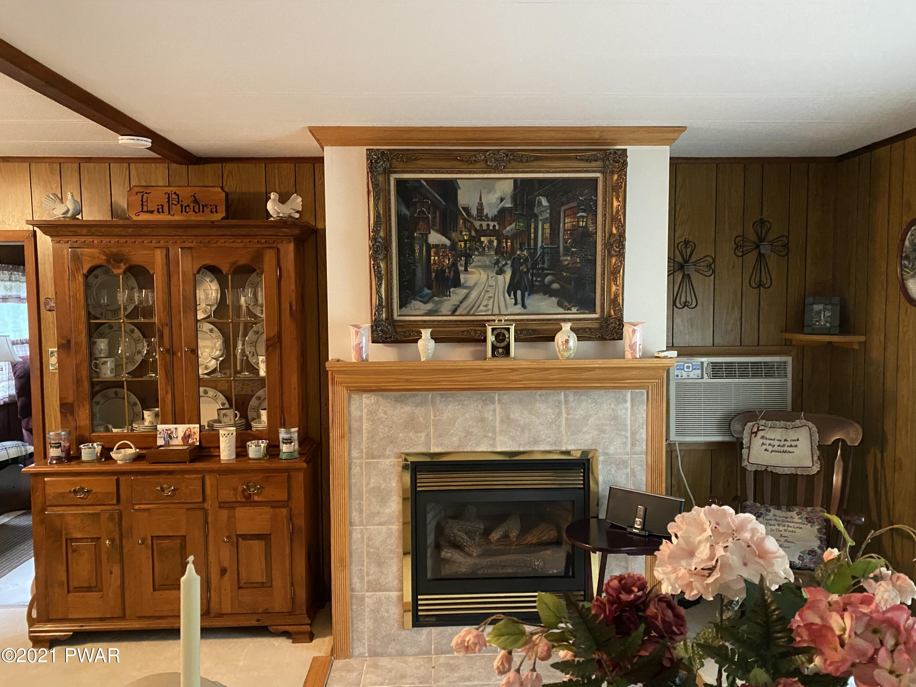 125 Maple Ridge Drive Hawley, PA 18428 - Photo 18 of 49 a living room with furniture and a fireplace