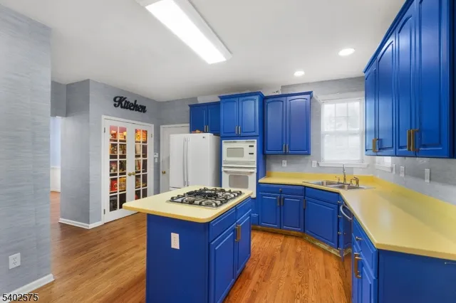 a kitchen with a sink stove and wooden cabinets