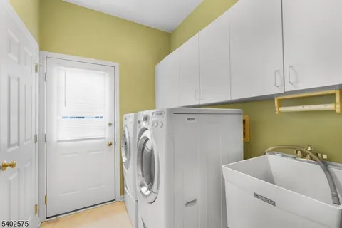 a bathroom with a sink and a washer dryer