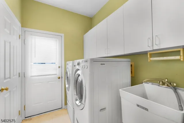 a bathroom with a sink and a washer dryer