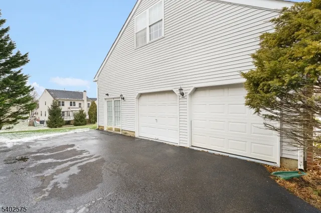 a view of a parking space in front of a house
