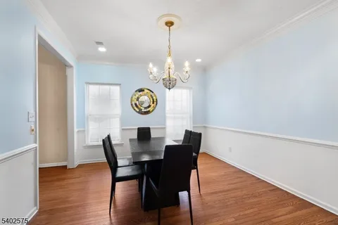 a view of a dining room with furniture and chandelier