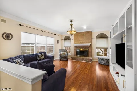 a living room with furniture fireplace and flat screen tv