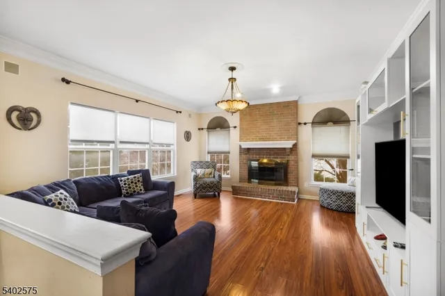 a living room with furniture fireplace and flat screen tv