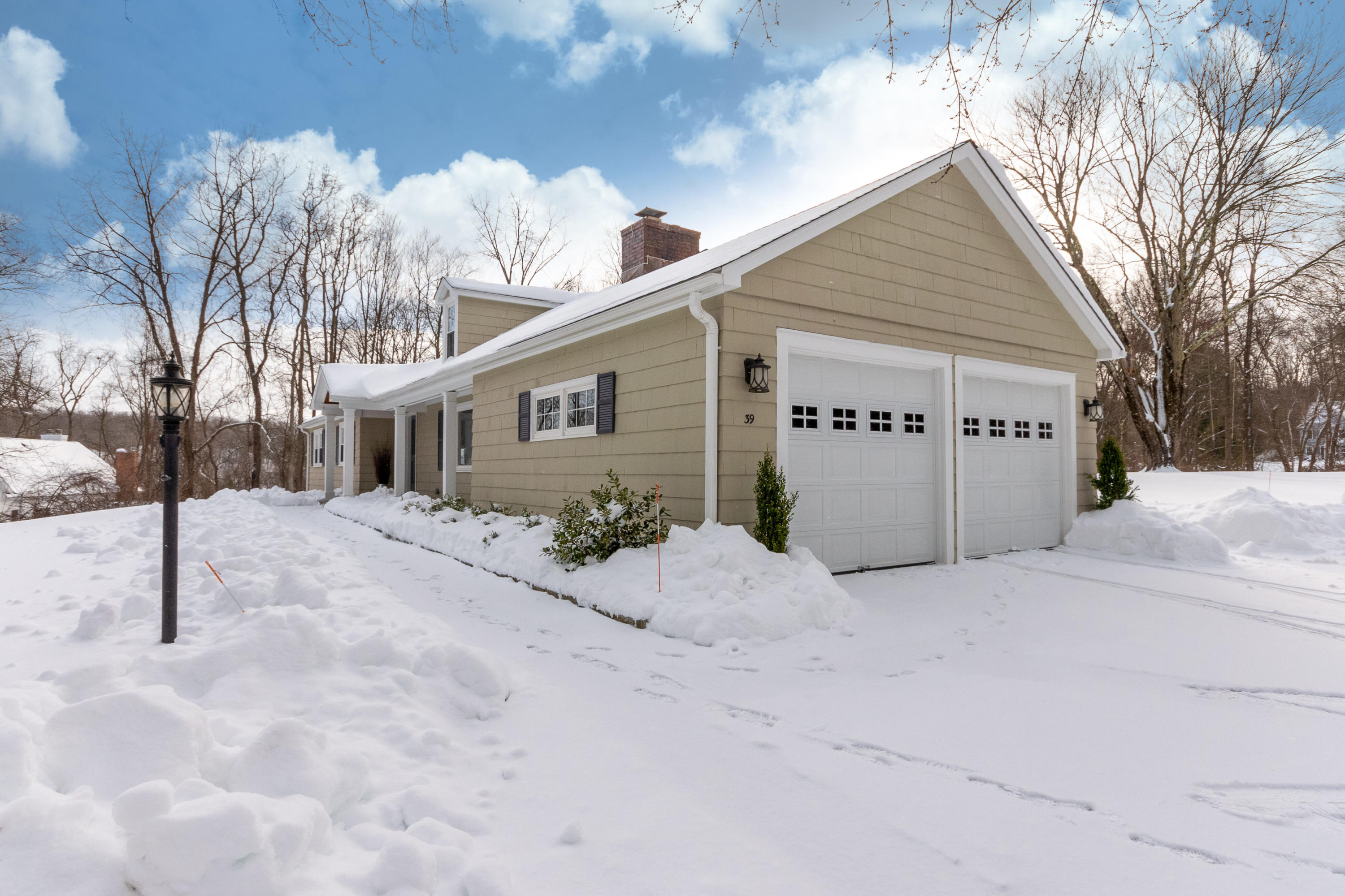 39 Scribner Hill Road Wilton, CT 06897 - Photo 2 of 25 a view of a house with a snow in the yard