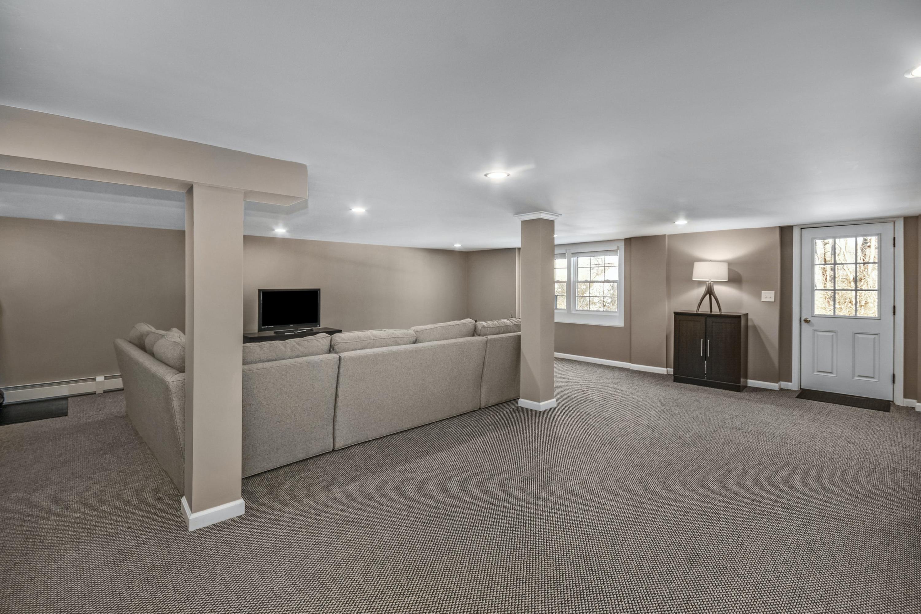39 Scribner Hill Road Wilton, CT 06897 - Photo 20 of 25 a living room with furniture and a flat screen tv