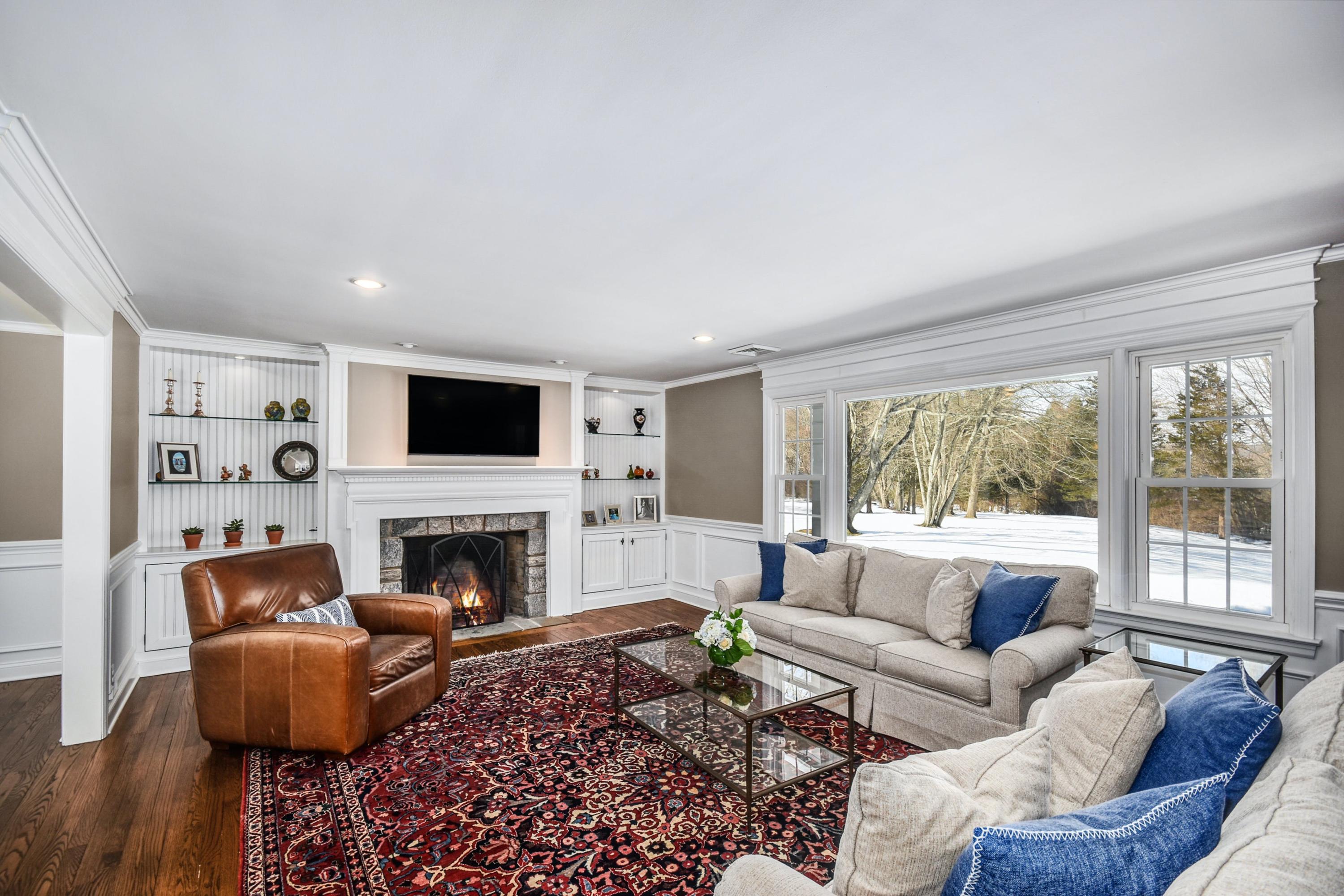 39 Scribner Hill Road Wilton, CT 06897 - Photo 5 of 25 a living room with furniture fireplace and a large window