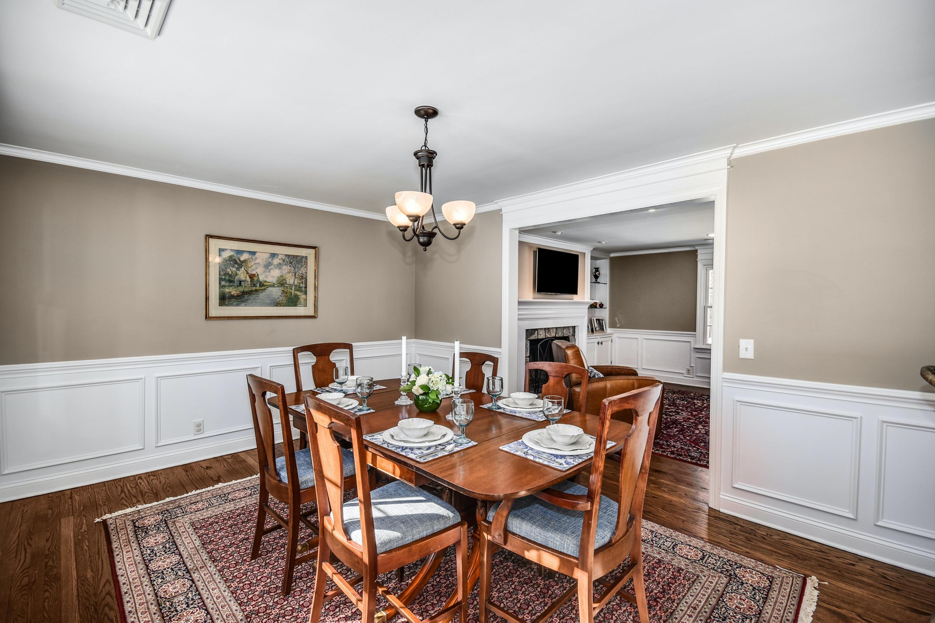 39 Scribner Hill Road Wilton, CT 06897 - Photo 7 of 25 a dining room with furniture a chandelier and wooden floor