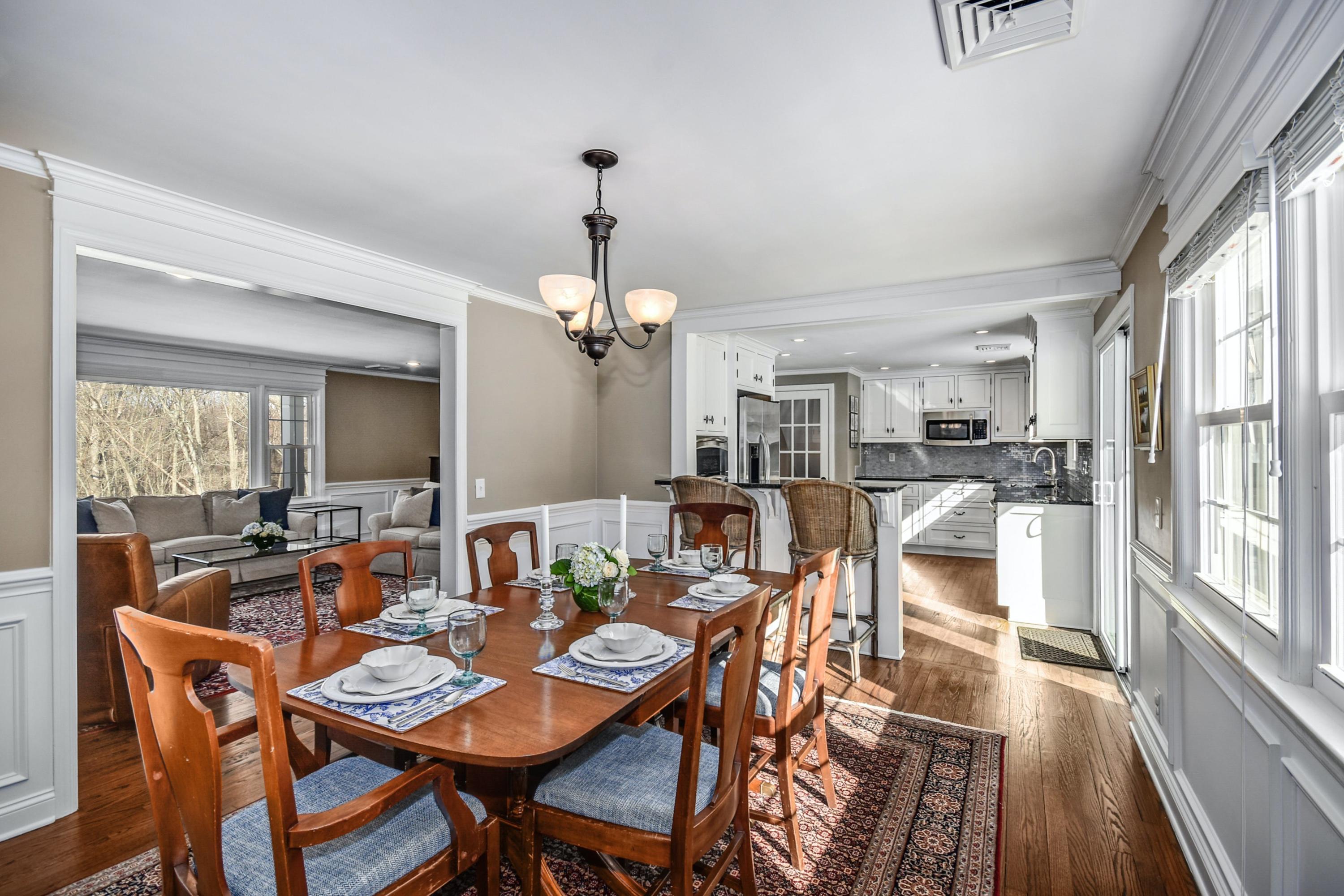 39 Scribner Hill Road Wilton, CT 06897 - Photo 9 of 25 a dining room with furniture a chandelier and wooden floor