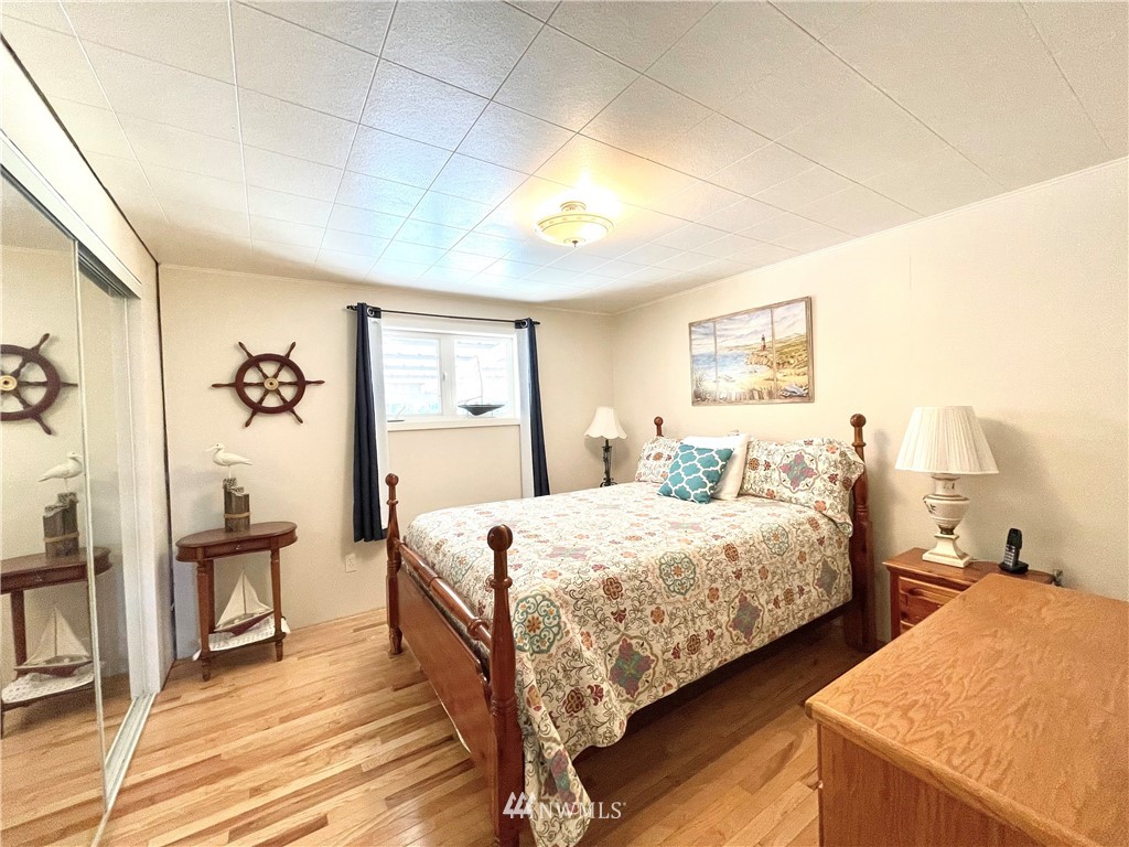 28 Dixon Road Omak, WA 98841 - Photo 23 of 39 a bedroom with a bed and wooden floor