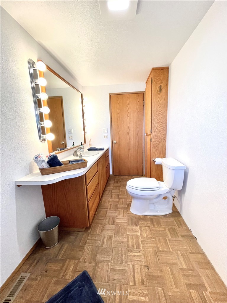 28 Dixon Road Omak, WA 98841 - Photo 26 of 39 a bathroom with a sink mirror vanity and toilet