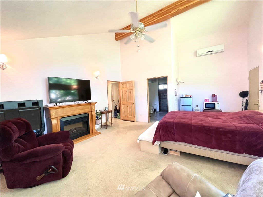 28 Dixon Road Omak, WA 98841 - Photo 29 of 39 a spacious bedroom with a bed and a flat screen tv