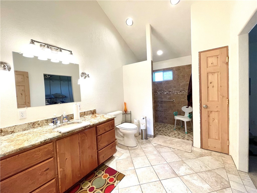 28 Dixon Road Omak, WA 98841 - Photo 30 of 39 a spacious bathroom with a granite countertop sink toilet a mirror and shower