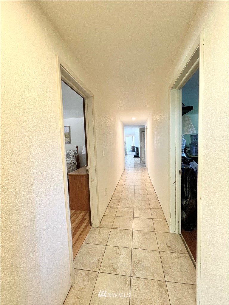 28 Dixon Road Omak, WA 98841 - Photo 32 of 39 a hallway with view of living room with a sink and a mirror